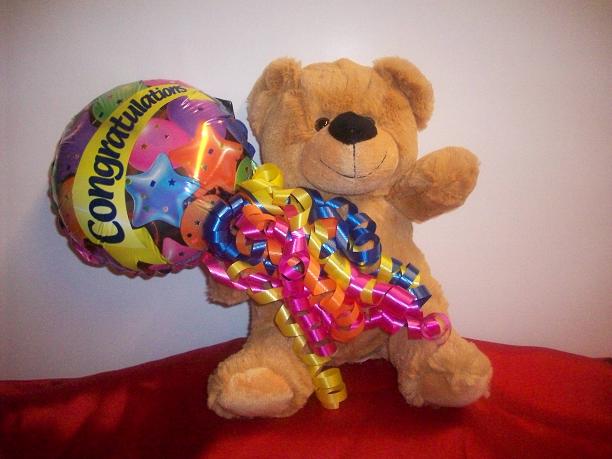 Bear holding balloon